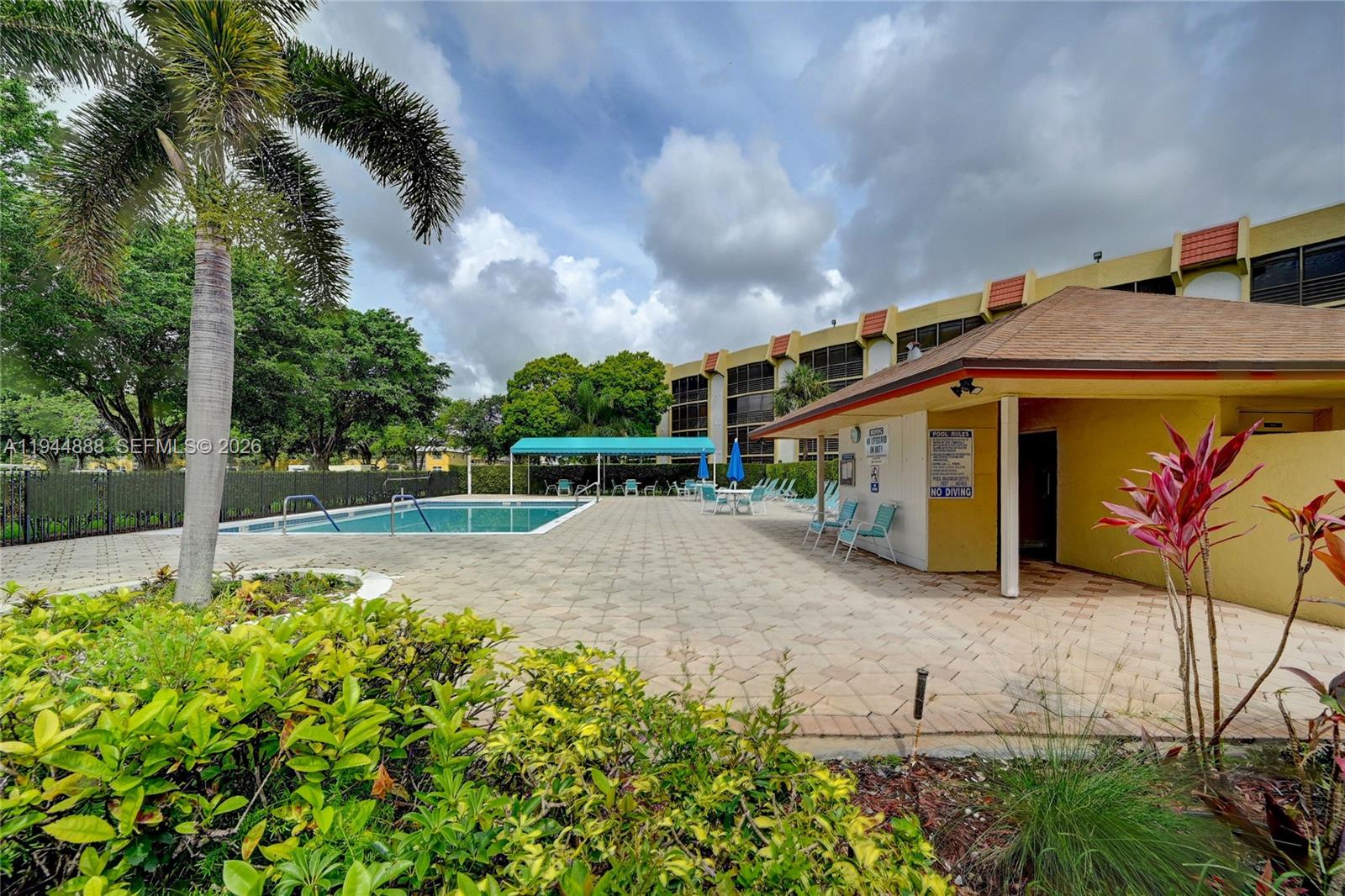 23344 Carolwood Lane, Unit 303 Boca Raton, FL 33428 - Photo 22 of 26 a view of a house with a yard