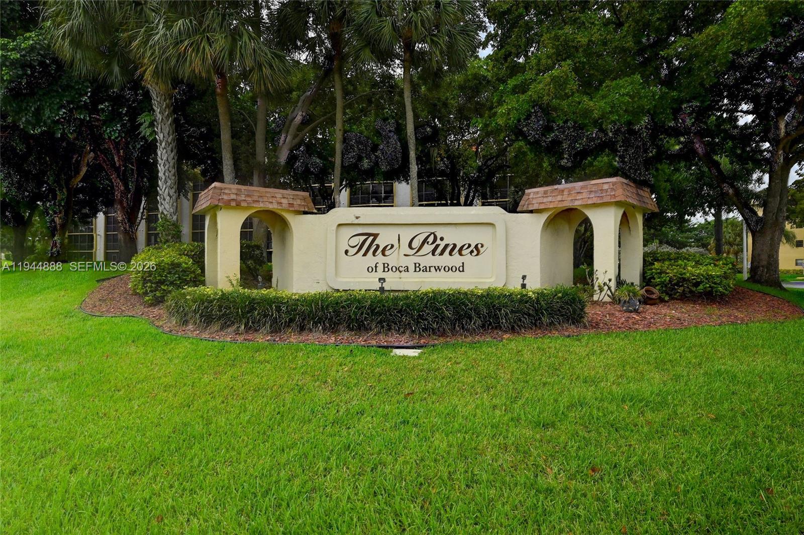 23344 Carolwood Lane, Unit 303 Boca Raton, FL 33428 - Photo 24 of 26 a front view of a house with garden