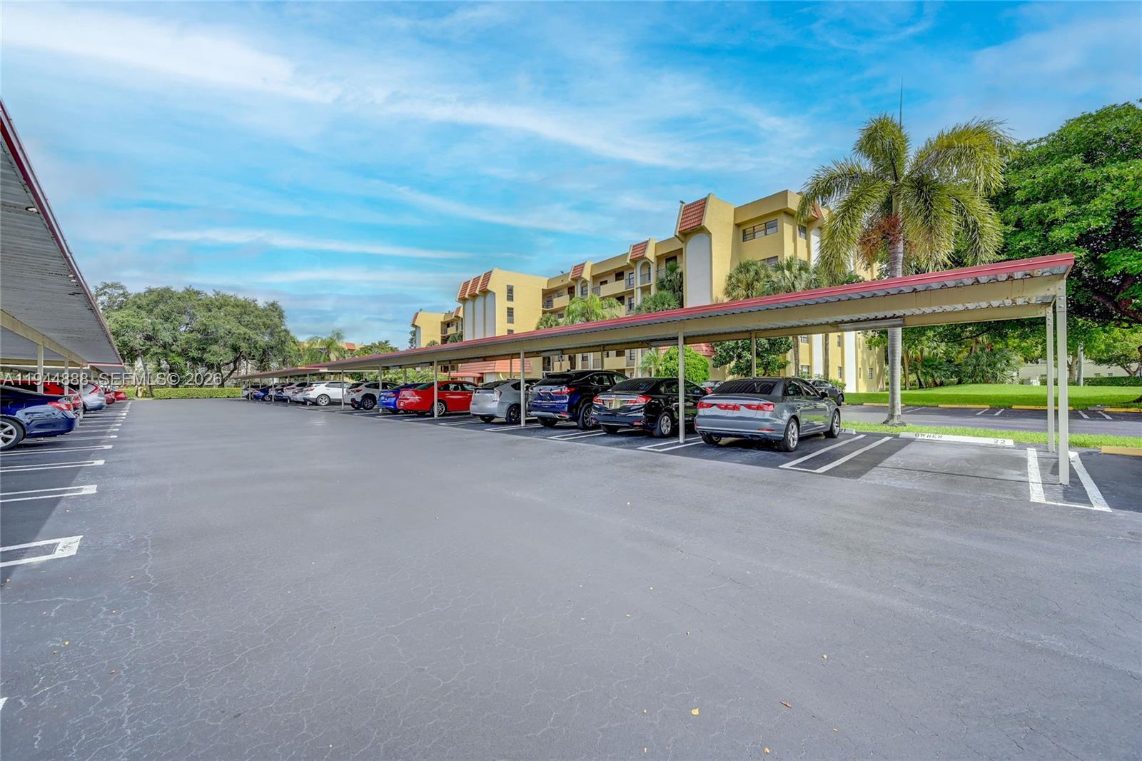 23344 Carolwood Lane, Unit 303 Boca Raton, FL 33428 - Photo 25 of 26 a view of a street with cars