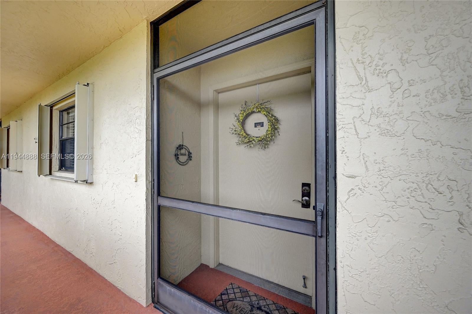 23344 Carolwood Lane, Unit 303 Boca Raton, FL 33428 - Photo 26 of 26 a bathroom with a shower and mirror