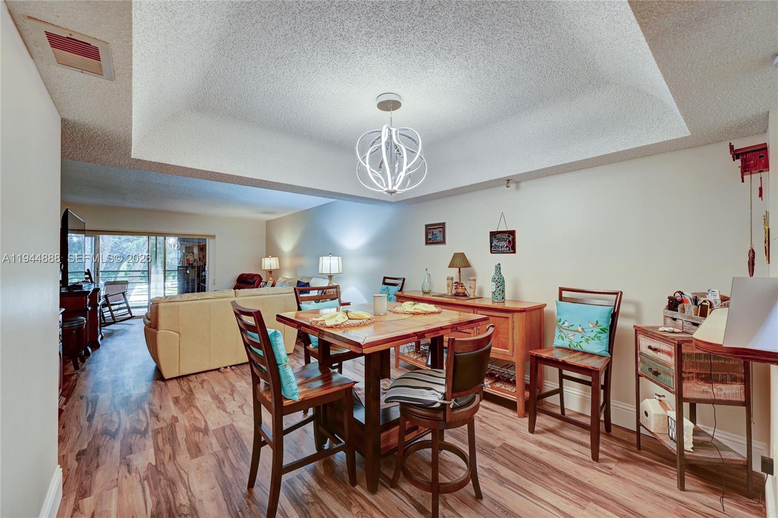 23344 Carolwood Lane, Unit 303 Boca Raton, FL 33428 - Photo 3 of 26 a view of a dining room with furniture window and wooden floor
