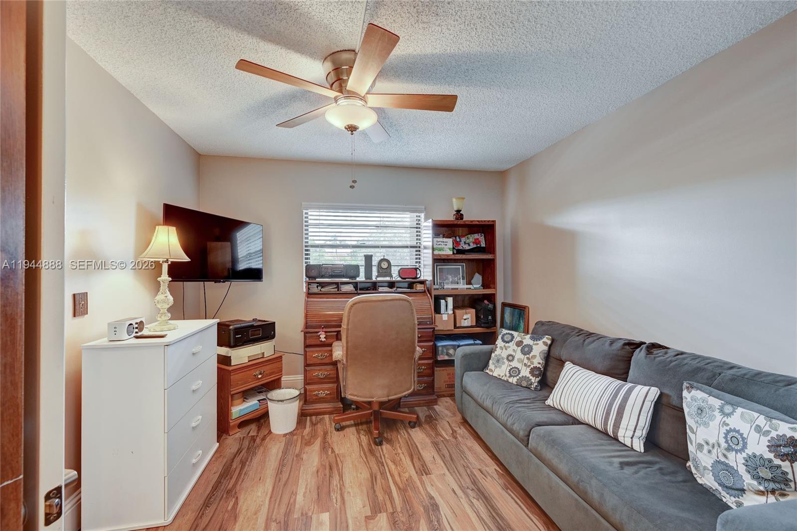 23344 Carolwood Lane, Unit 303 Boca Raton, FL 33428 - Photo 6 of 26 a living room with furniture and a flat screen tv