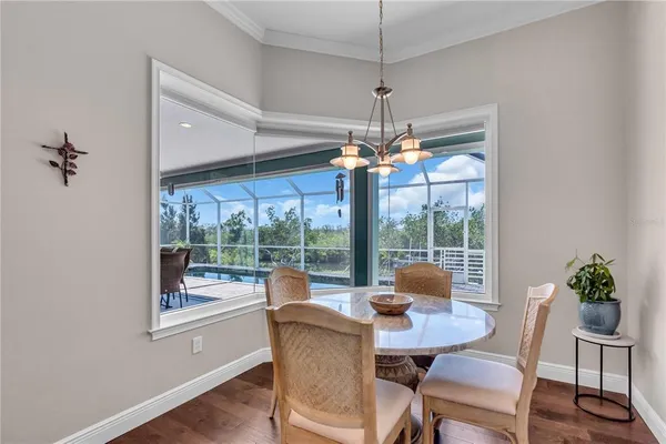 a view of a dining room with furniture wooden floor and chandelier