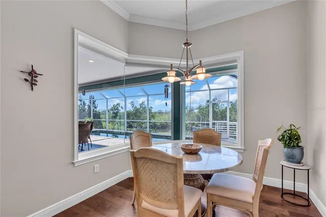a view of a dining room with furniture wooden floor and chandelier
