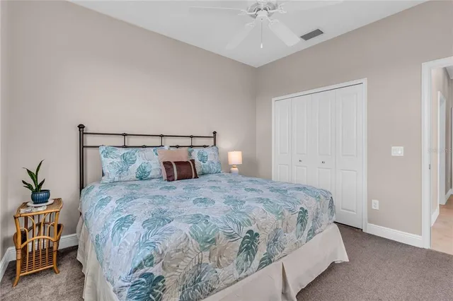 a bedroom with a bed and table chair