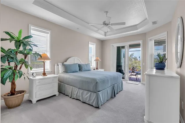 a bedroom with bed and a potted plant