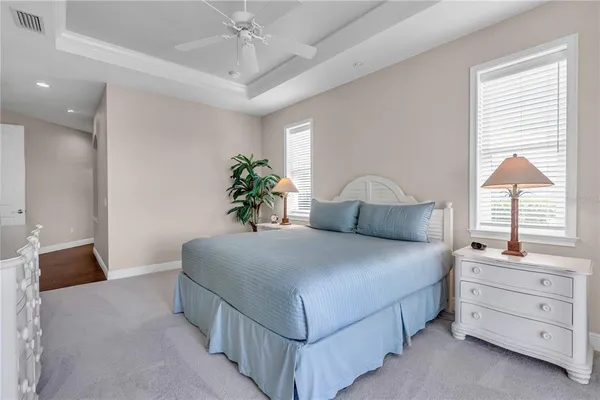 a bedroom with a bed and a potted plant