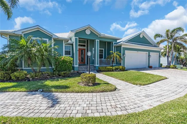 a front view of a house with a garden and yard