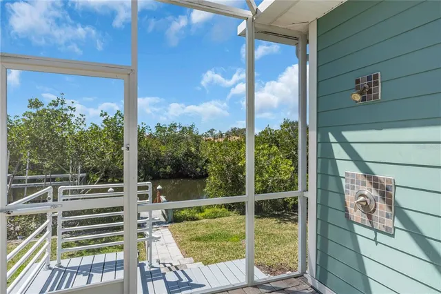 a view of a balcony with floor to ceiling windows with wooden floor