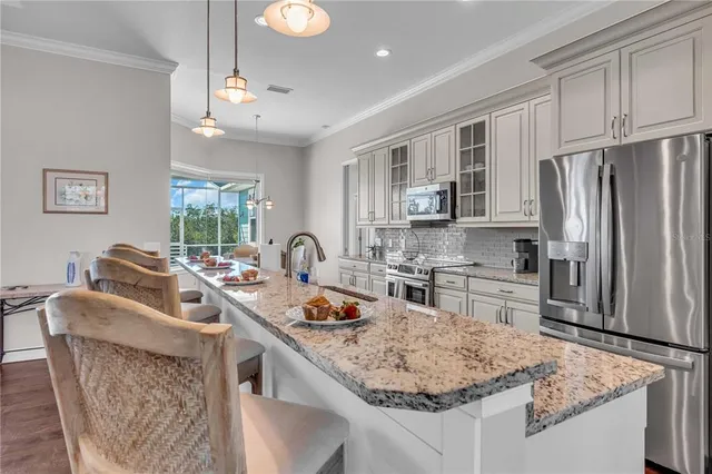 a kitchen with stainless steel appliances granite countertop a sink stove and refrigerator