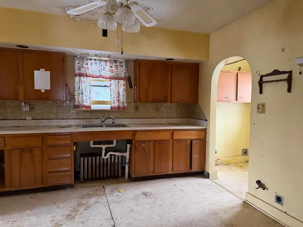 a spacious bathroom with a granite countertop tub sink and mirror