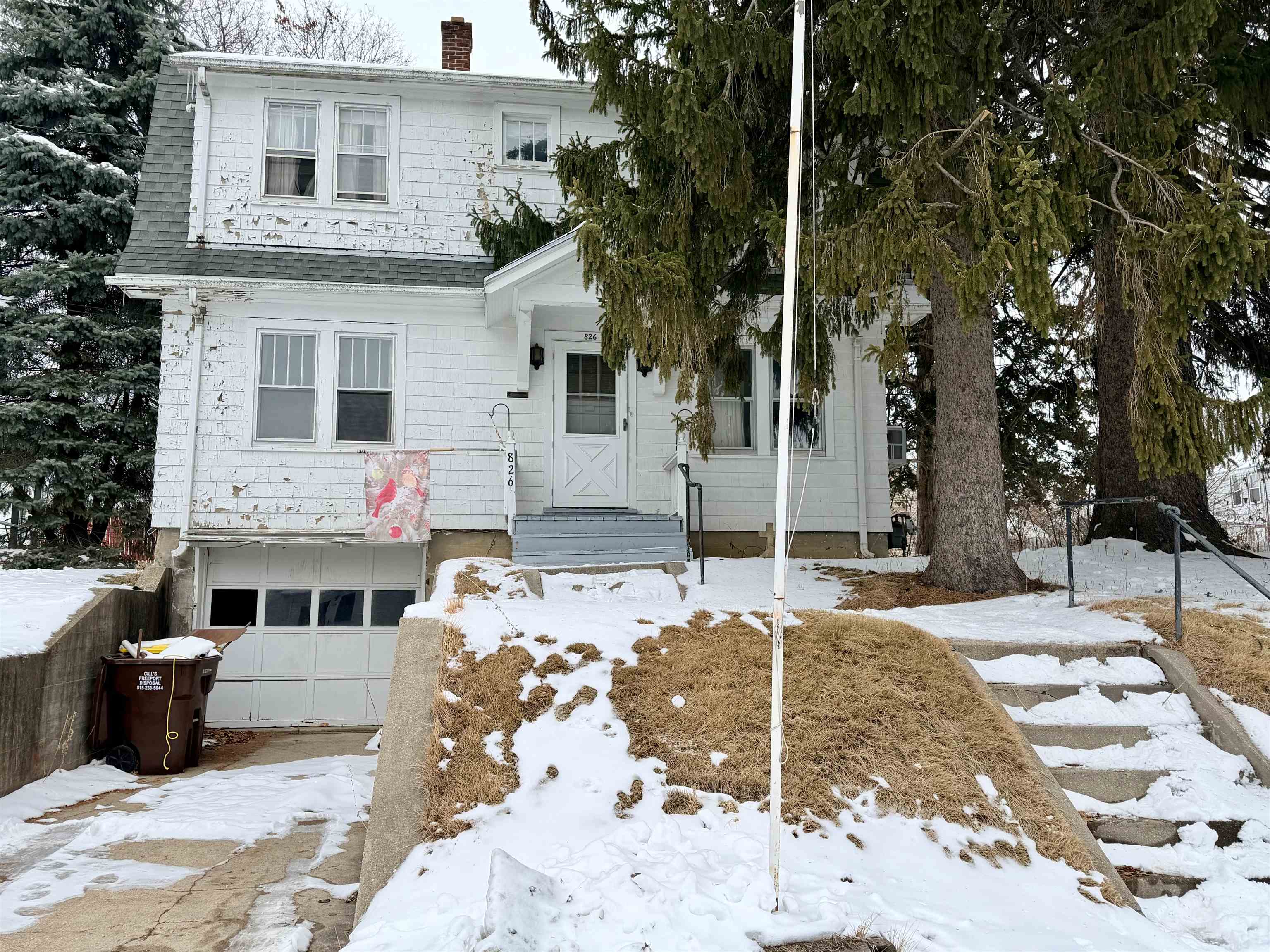 826 West Chestnut Street Freeport, IL 61032 - Photo 2 of 30 a view of a white house with large windows