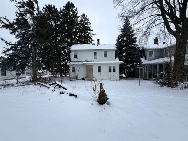 a view of a house with a snow in the background