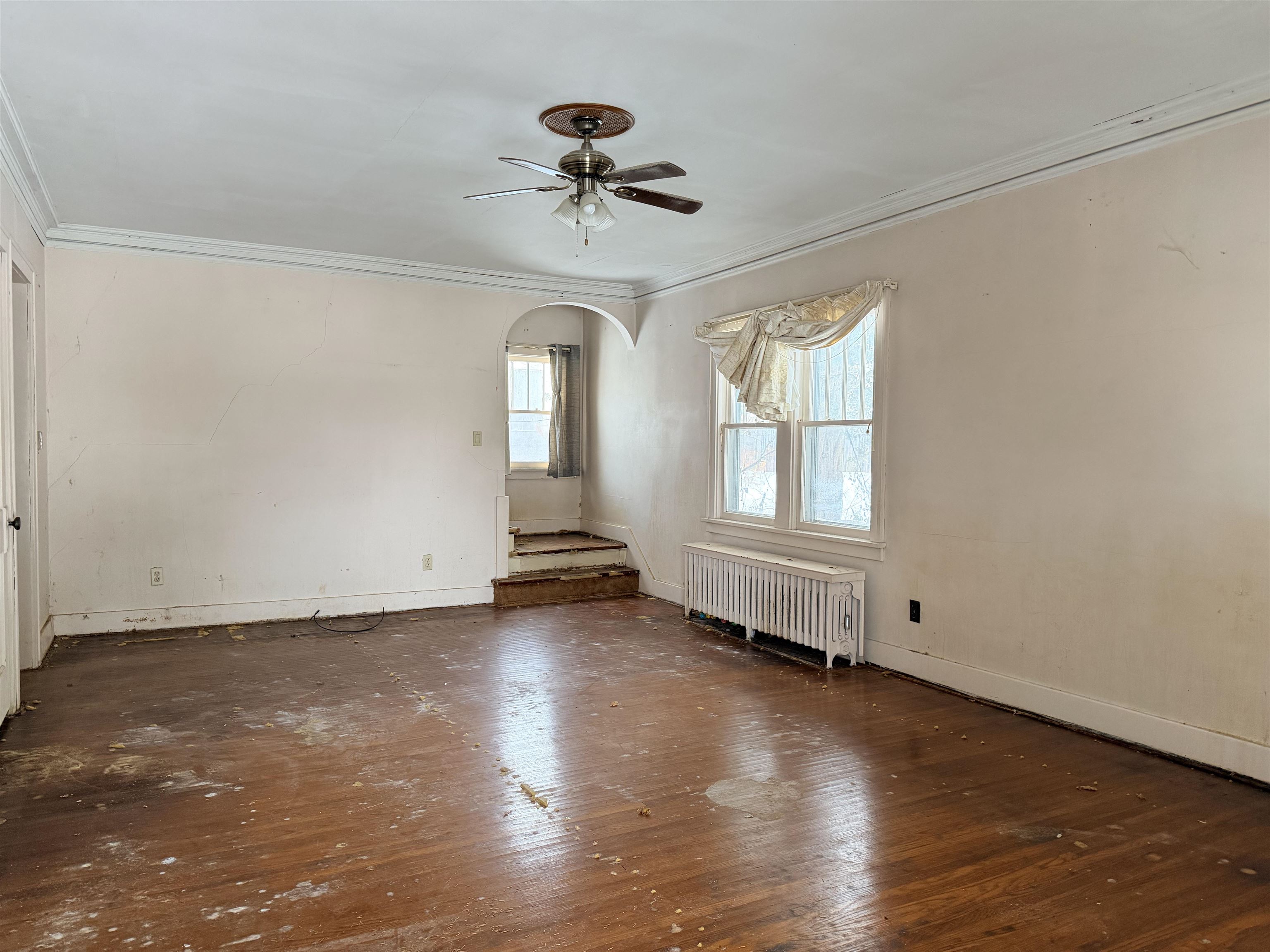 826 West Chestnut Street Freeport, IL 61032 - Photo 6 of 30 an empty room with wooden floor chandelier fan and windows