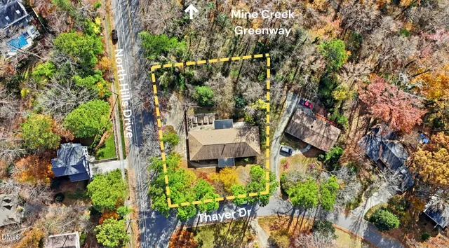 an aerial view of a house with a yard and garden