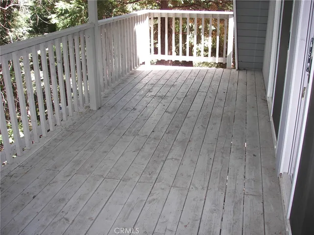 a view of a kitchen with wooden floor and a sink