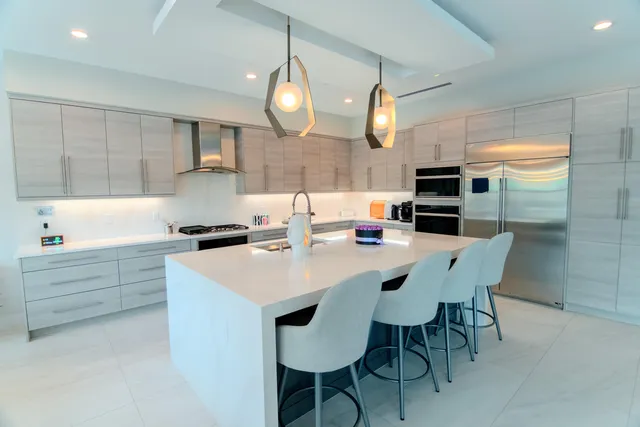 a bedroom with furniture and a large window