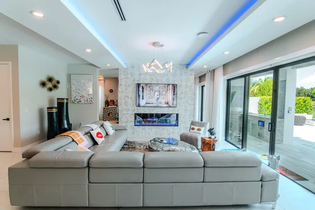a living room with furniture and a potted plant