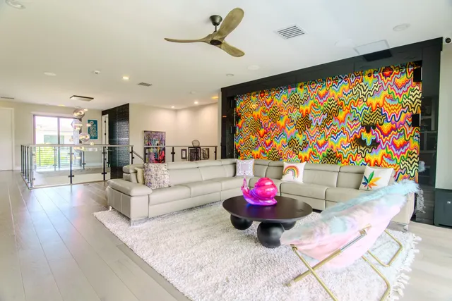 a bedroom with a bed and a painting on the wall