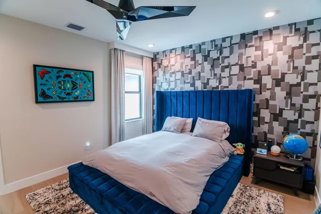 a living room with furniture and painting on the wall