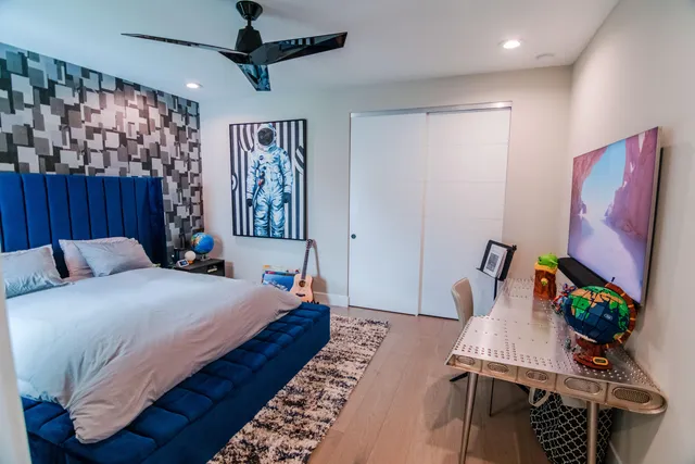 a room with gym equipment and a flat screen tv