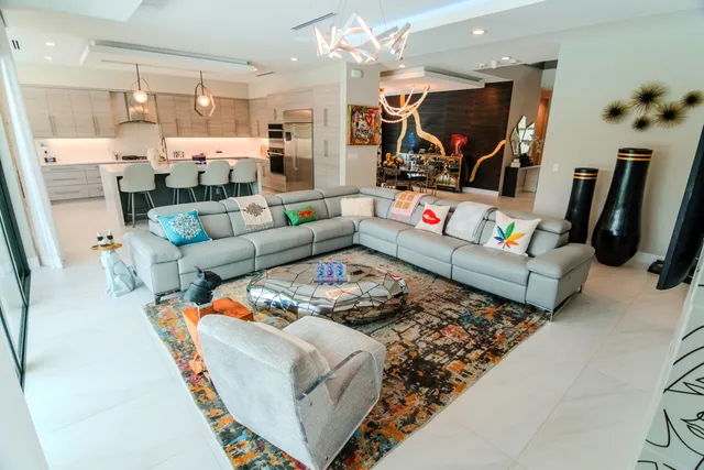 a living room with furniture a rug and a large window