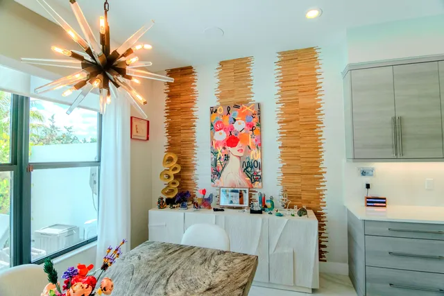 a kitchen with stainless steel appliances a center island and a refrigerator