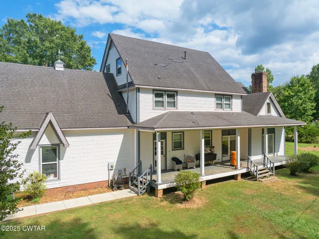 a view of a big yard with large trees