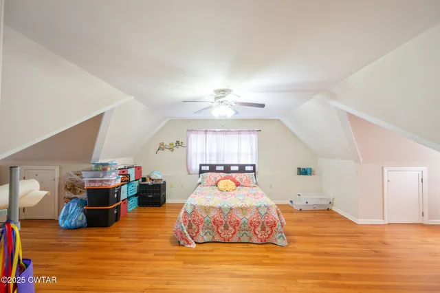 a view of staircase with wooden floor and fan