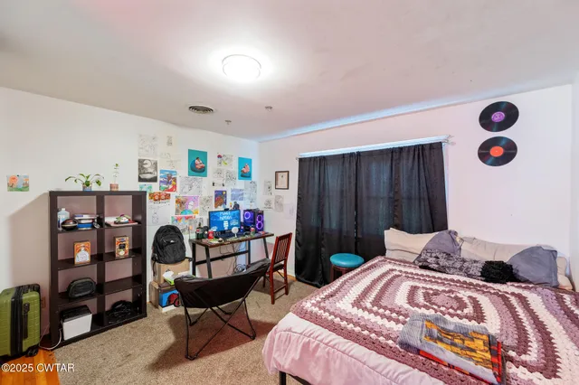 a view of a dining room with furniture wooden floor and a chandelier