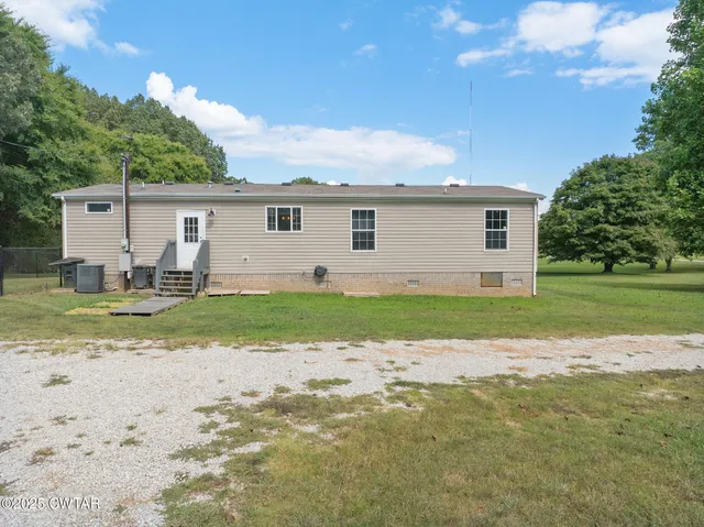 a kitchen with kitchen island granite countertop a sink appliances cabinets and counter space