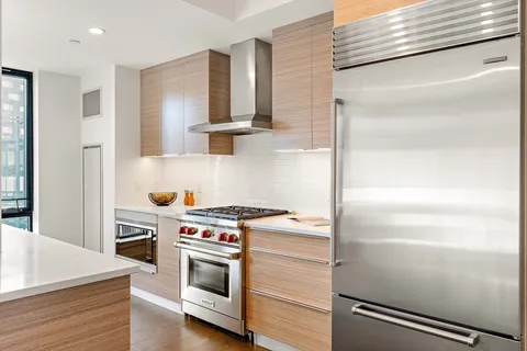a kitchen with a stove and a refrigerator