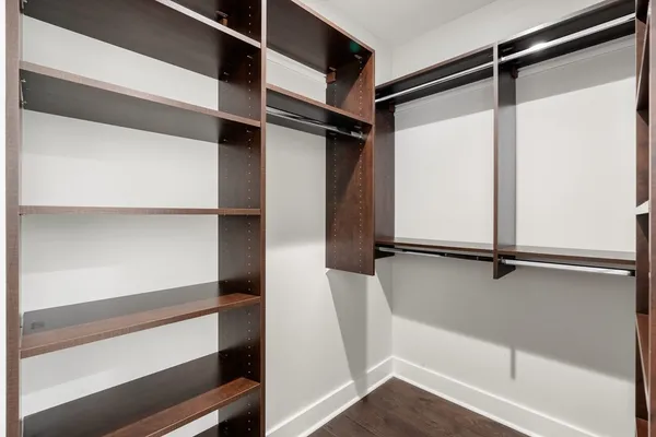 a view of walk in closet with empty racks
