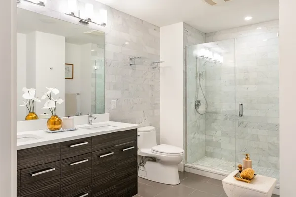 a bathroom with a sink a toilet and shower