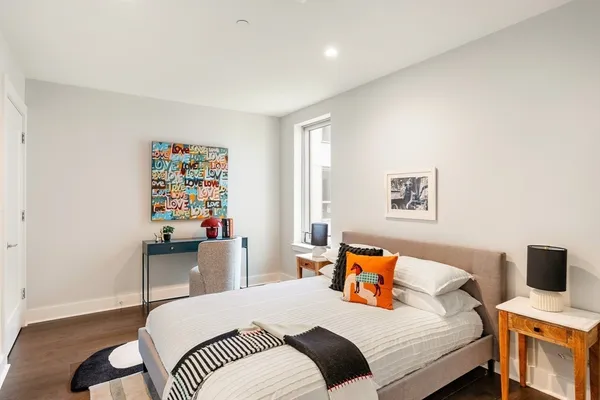 a bedroom with a bed and a workspace