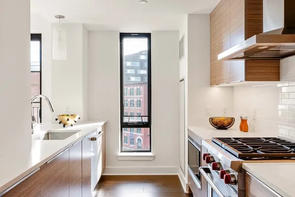 a kitchen with stainless steel appliances granite countertop a stove and a sink