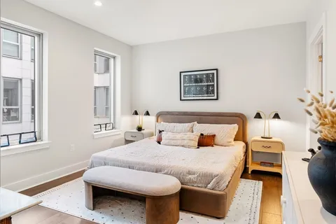 a bedroom with furniture and a window