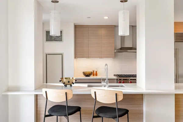 a kitchen with a sink cabinets and window