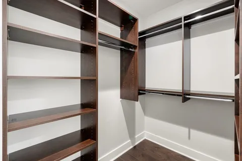 a view of walk in closet with empty racks