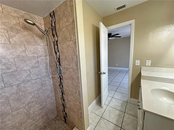 a bathroom with a shower and a sink