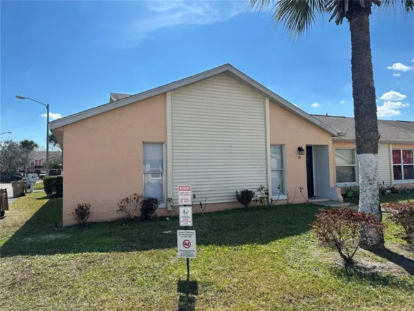 a view of a white house with a yard