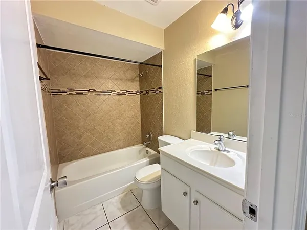 a view of a livingroom with a ceiling fan and window