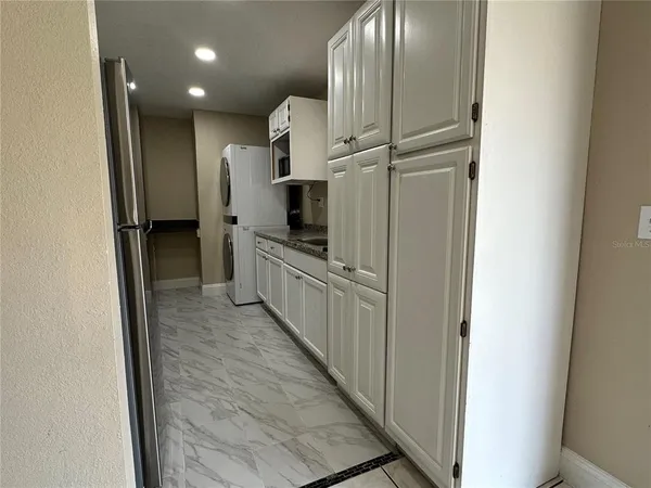 a view of a kitchen from the hallway