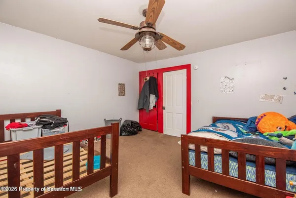 a bedroom with furniture and a baby crib
