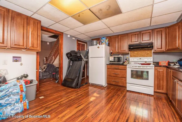 a kitchen with stainless steel appliances granite countertop a refrigerator and a stove top oven