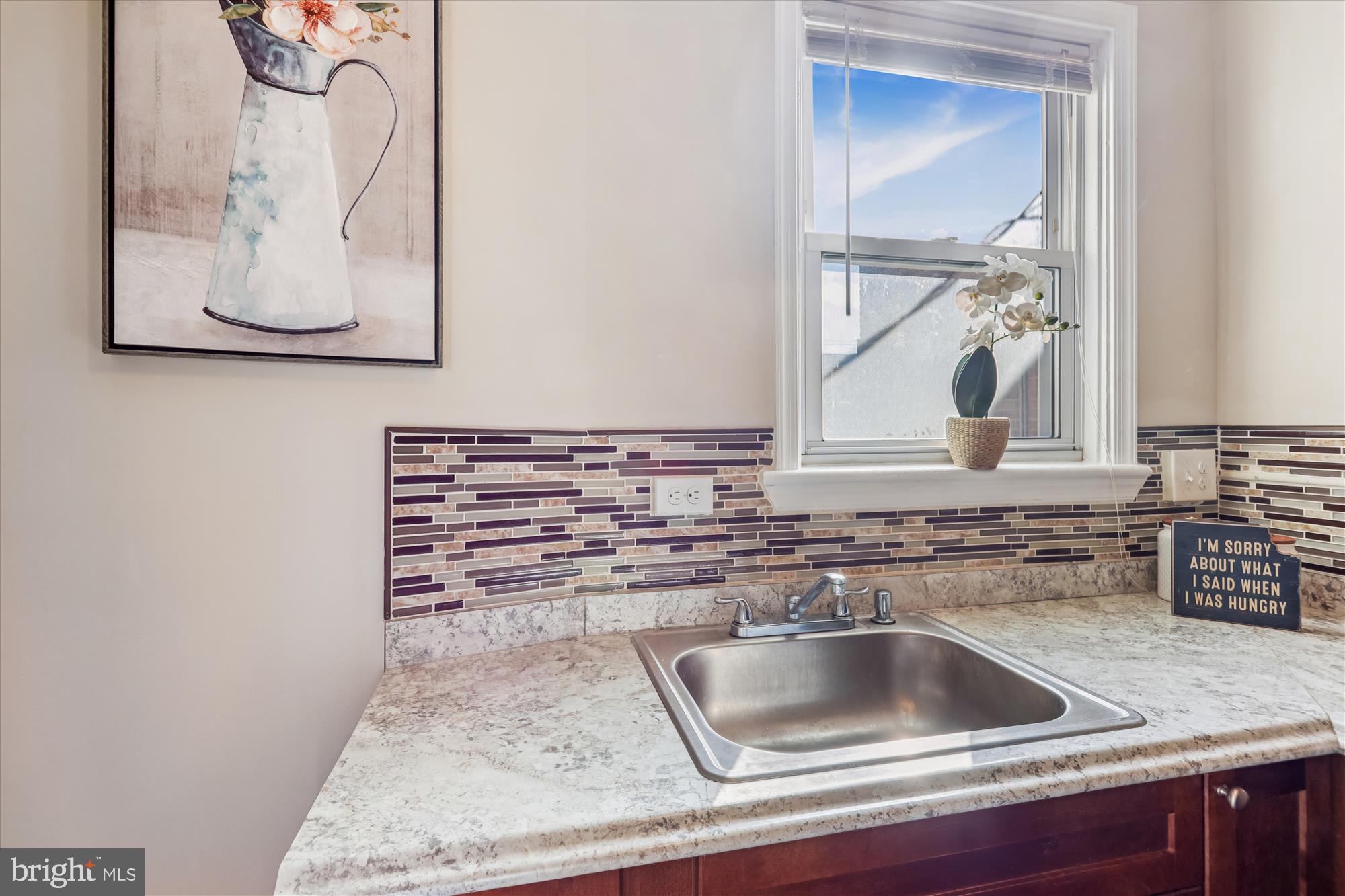 149 Denison Street, Unit 2 Baltimore, MD 21229 - Photo 11 of 24 a kitchen with a sink and a stove with wooden floor