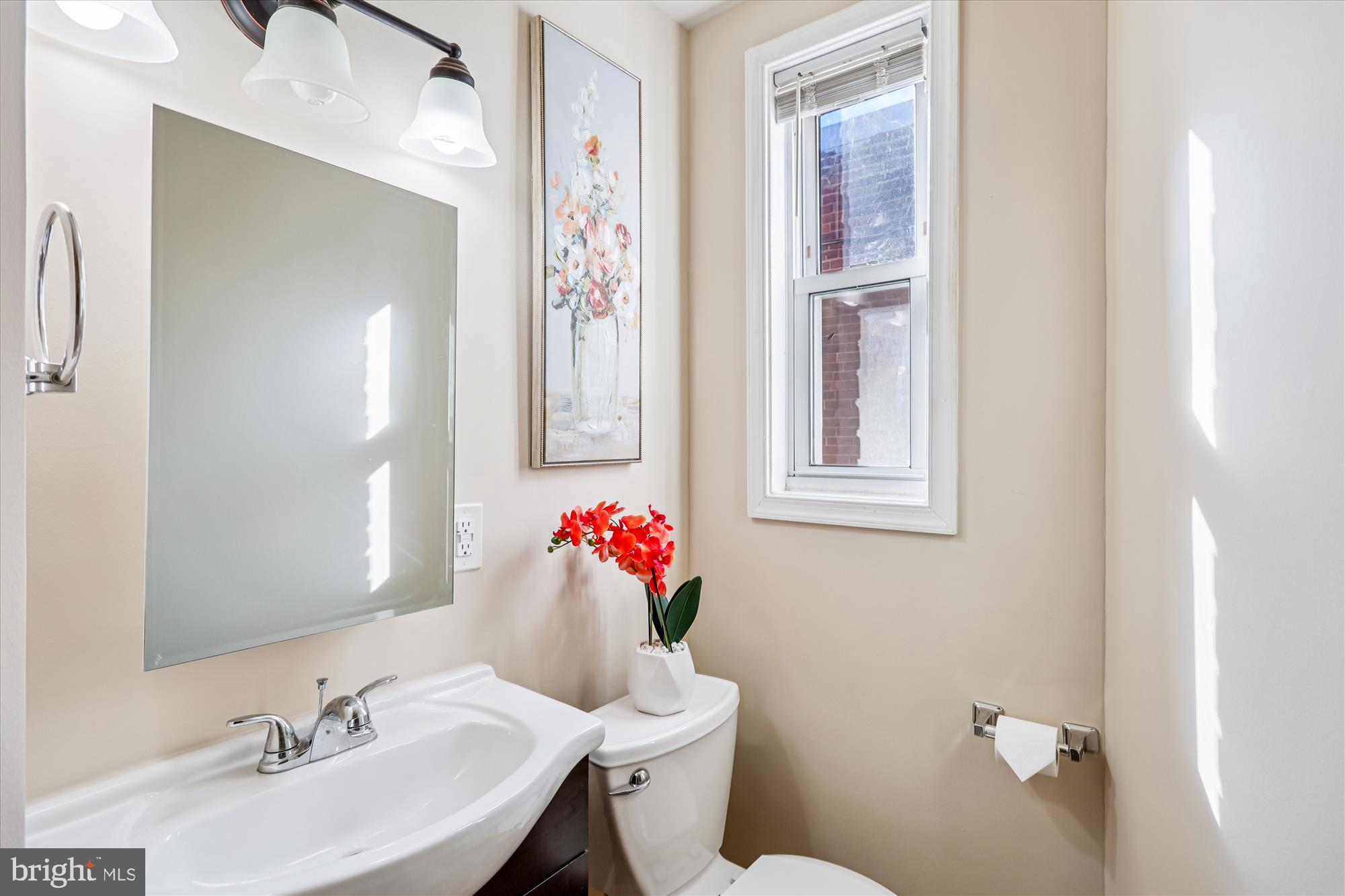 149 Denison Street, Unit 2 Baltimore, MD 21229 - Photo 13 of 24 a bathroom with a sink mirror and a toilet