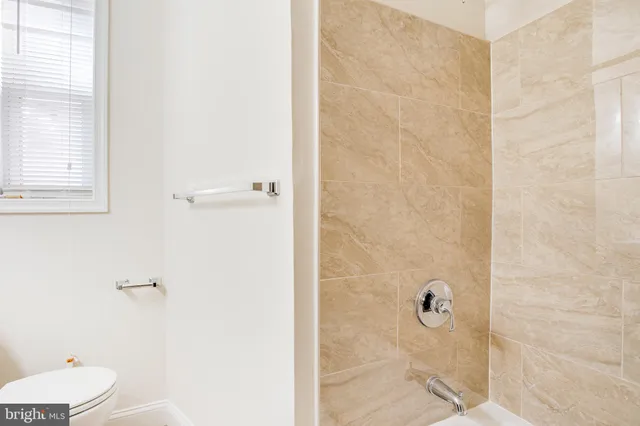 a bathroom with a granite countertop shower