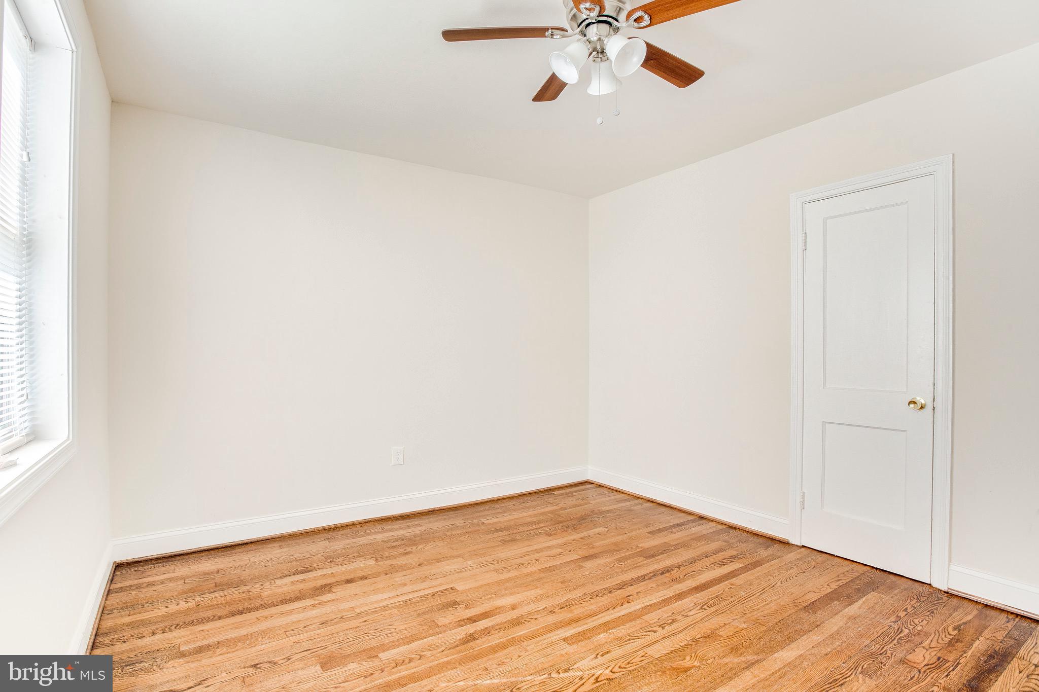 149 Denison Street, Unit 2 Baltimore, MD 21229 - Photo 15 of 19 a view of a room with wooden floor and fan