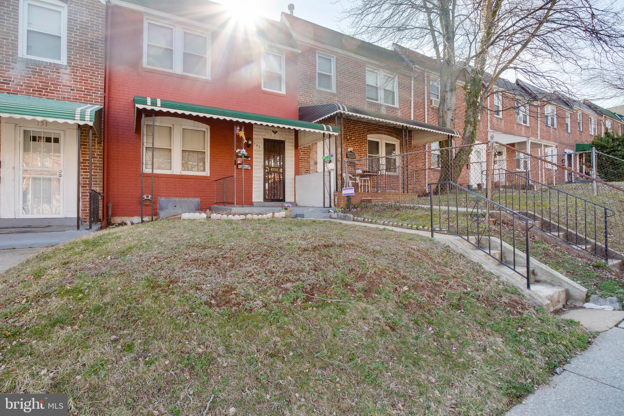 149 Denison Street, Unit 2 Baltimore, MD 21229 - Photo 18 of 19 a front view of a house with a yard